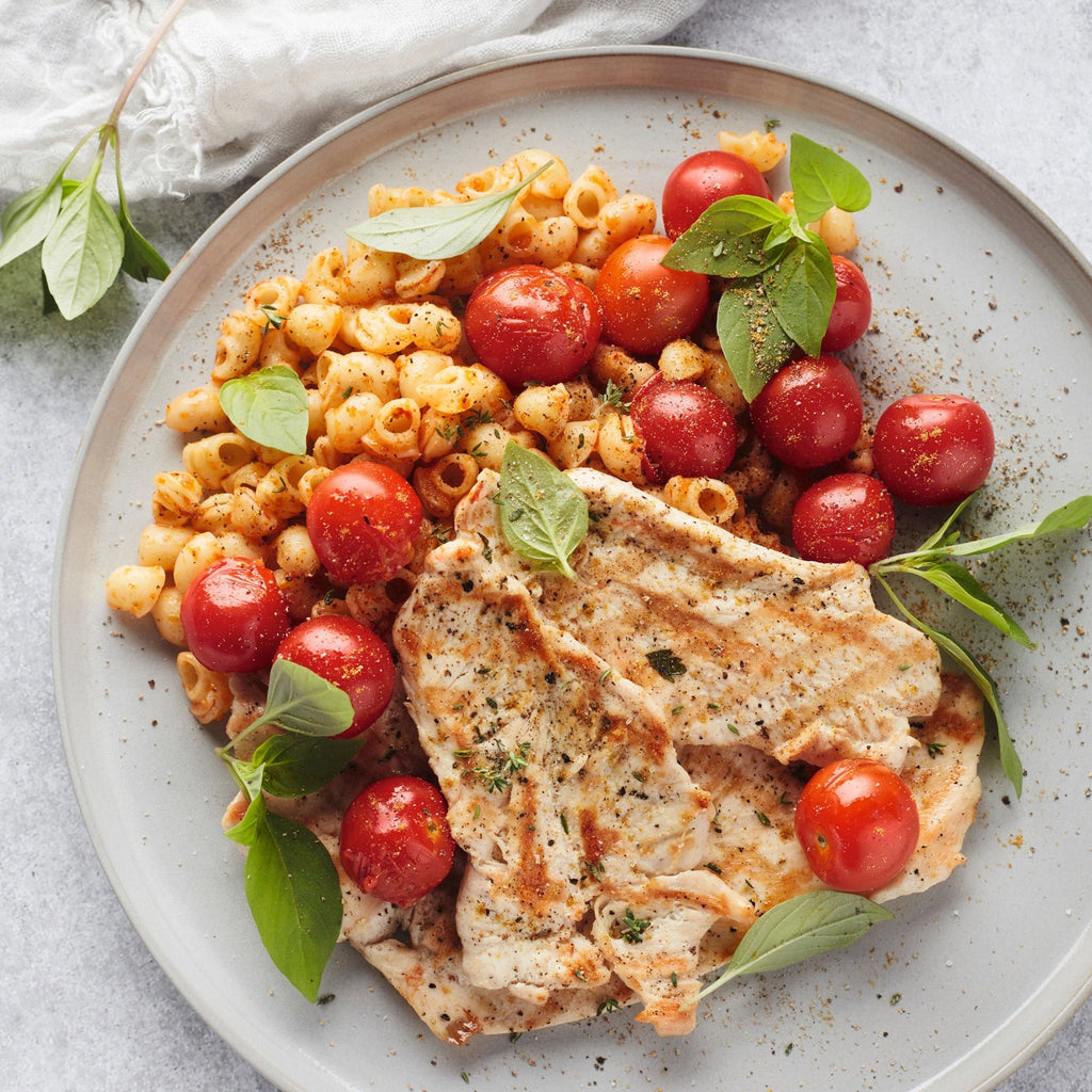 Pasta with grilled chicken fillets and tomatoes