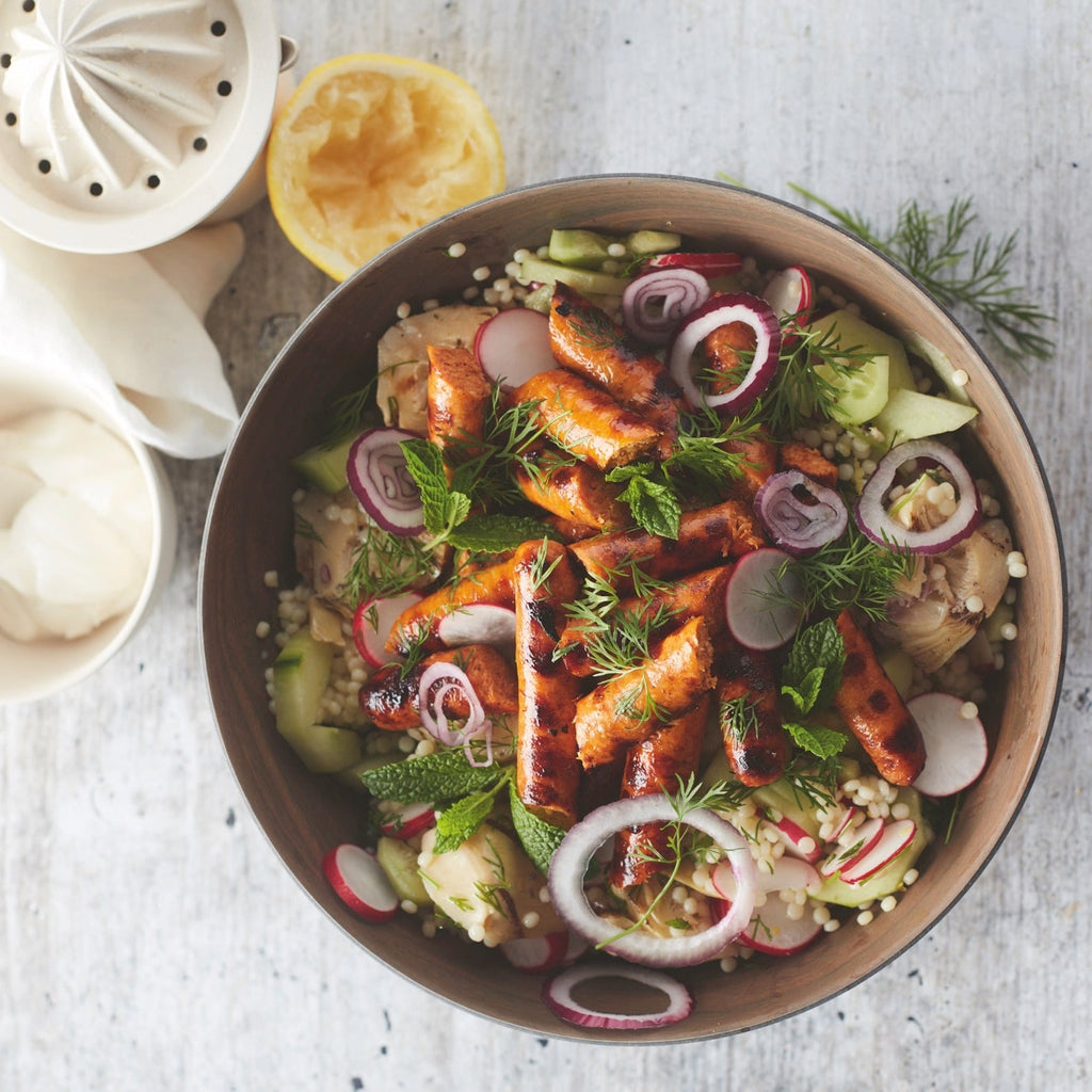 Grilled merguez sausage with pearl couscous, artichoke and cucumber